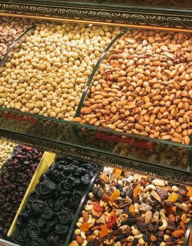 pexels photo 2386158 2386158 Colorful assortment of nuts and dried fruits in a market display, showcasing healthy snack options.