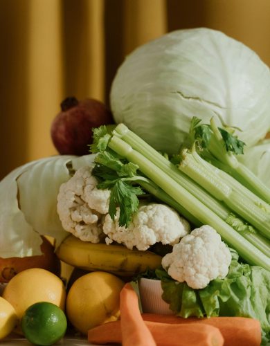 pexels photo 8455375 8455375 A vibrant assortment of fresh organic vegetables and fruits including cabbage, celery, and lemons.